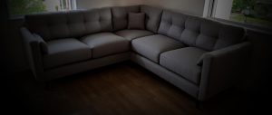 Dark fabric on upholstered corner sofa