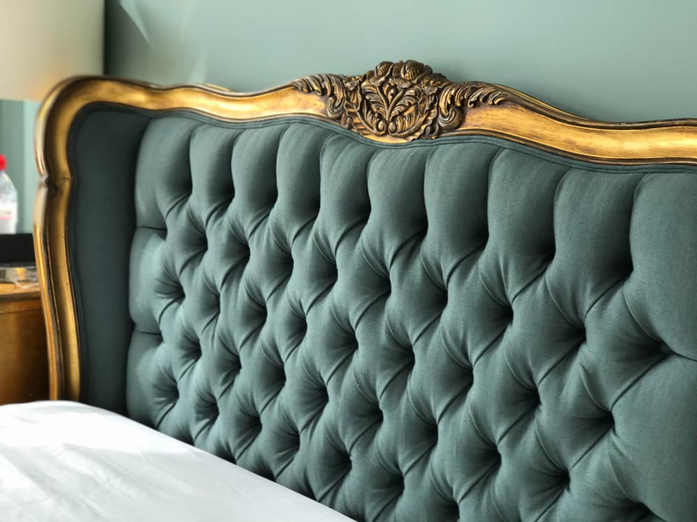 Golden frame green headboard upholstered with fabric